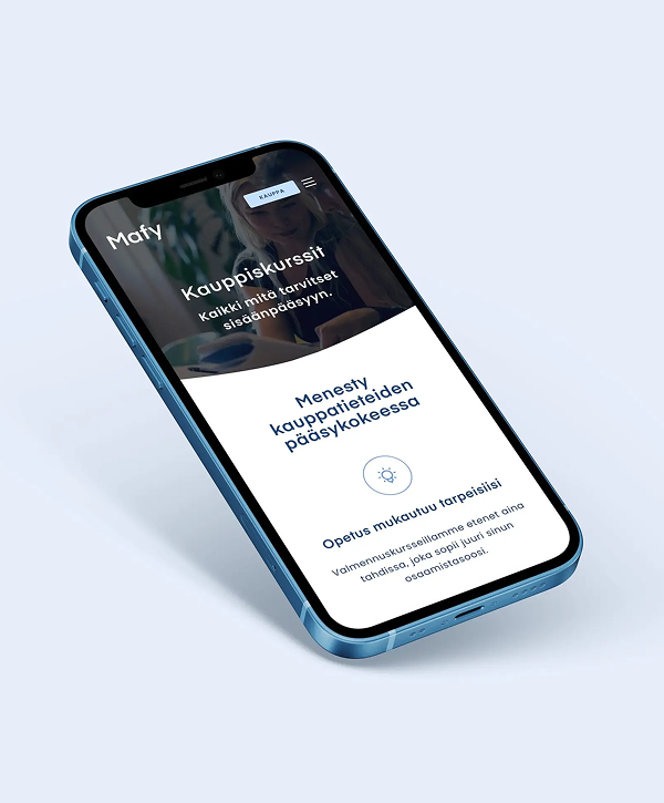 Angled blue smartphone on a pale background showing the Mafy mobile website in Finnish, with the Mafy logo, headline "Menesty kauppatieteiden pääsykokeessa" and a section reading "Opetus mukautuu tarpeisiisi" over a blurred header image.