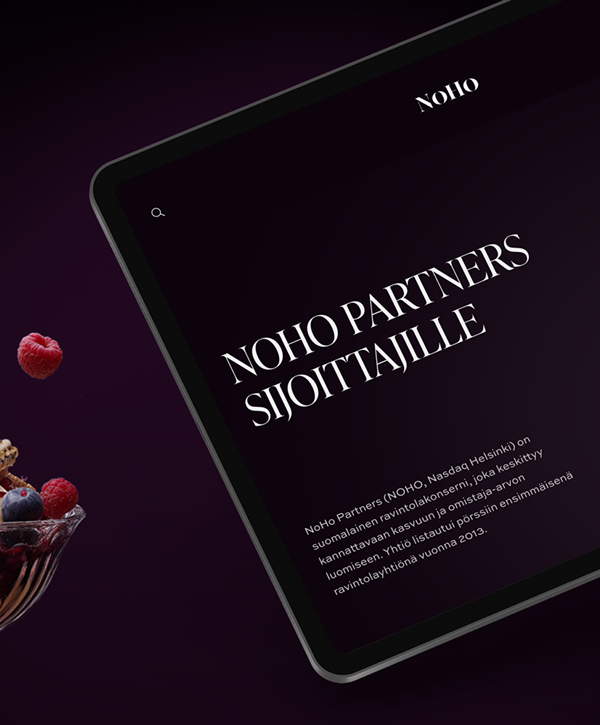 Tilted tablet on a dark purple background showing a Noho Partners investor web page in Finnish with a large white serif headline "NOHO PARTNERS SIJOITTAJILLE" and brief body text, with a partial glass dessert bowl of raspberries and blueberries visible at the left.